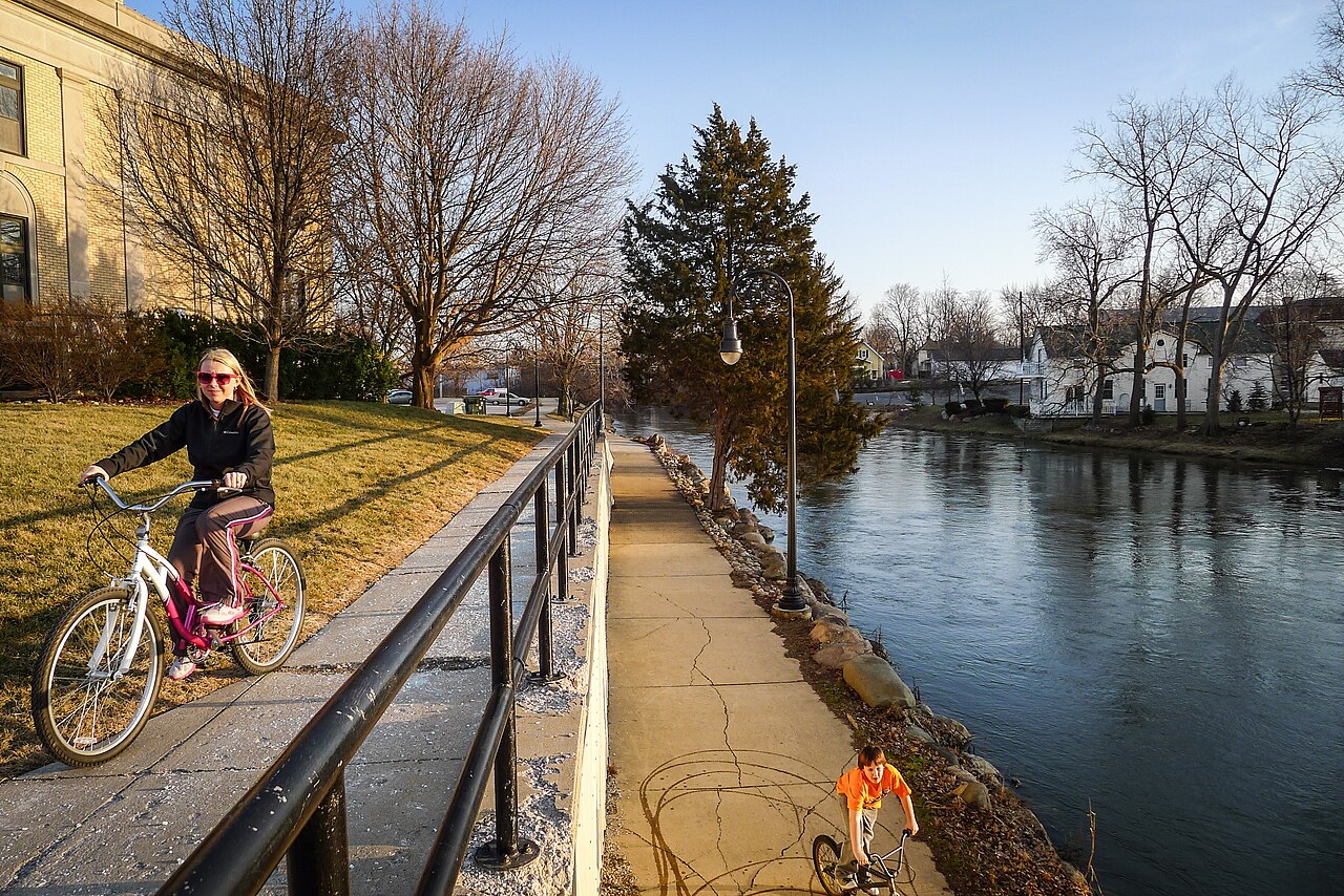 A bicyclist alongside the Shiawassee river in Owosso, MI